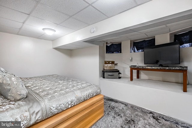 carpeted bedroom with a paneled ceiling