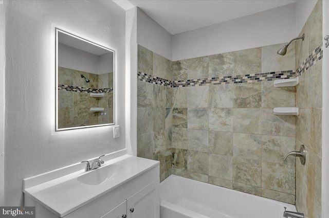 bathroom with vanity and tiled shower / bath