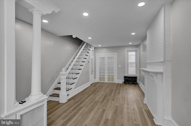 interior space featuring radiator and light hardwood / wood-style flooring