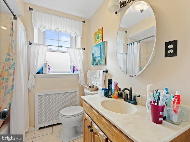 bathroom featuring vanity, radiator, tile patterned flooring, and toilet