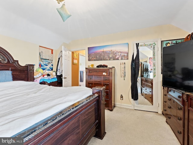 carpeted bedroom featuring lofted ceiling