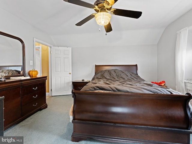 bedroom with vaulted ceiling, light colored carpet, and ceiling fan