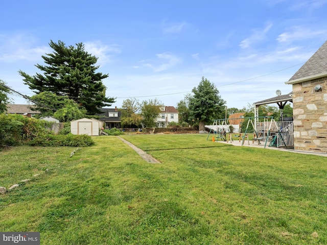 view of yard with a patio area and a storage shed