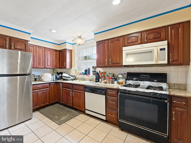 kitchen with ornamental molding, backsplash, white appliances, and light tile patterned flooring