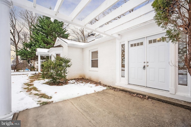 view of snow covered property entrance