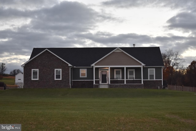 view of front facade with covered porch and a front yard