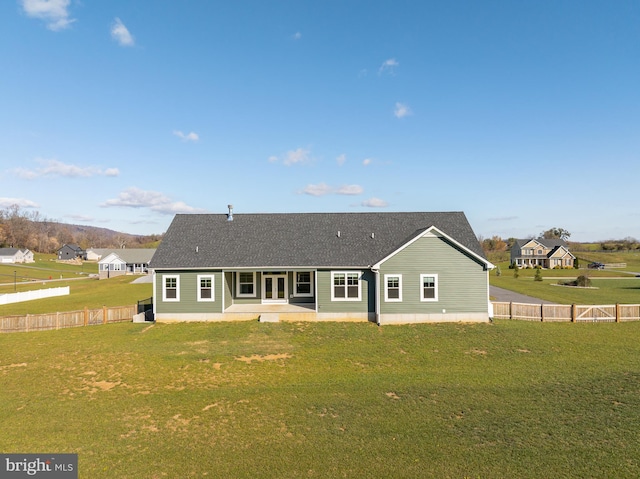 rear view of property featuring a lawn and a patio area