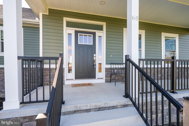 entrance to property featuring a porch