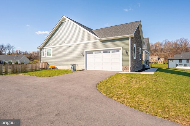 view of home's exterior featuring a yard and a garage