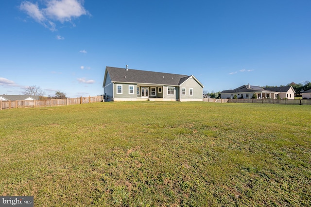 rear view of house featuring a lawn