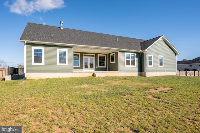 rear view of property featuring french doors and a yard