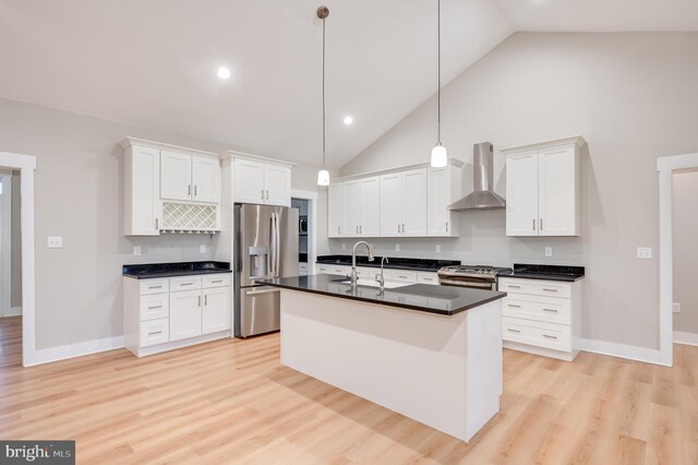 kitchen featuring white cabinetry, hanging light fixtures, wall chimney exhaust hood, and stainless steel appliances