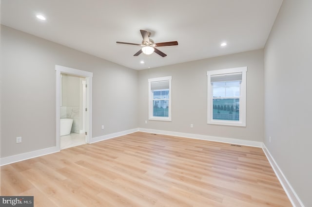 unfurnished bedroom with ceiling fan, light wood-type flooring, and connected bathroom