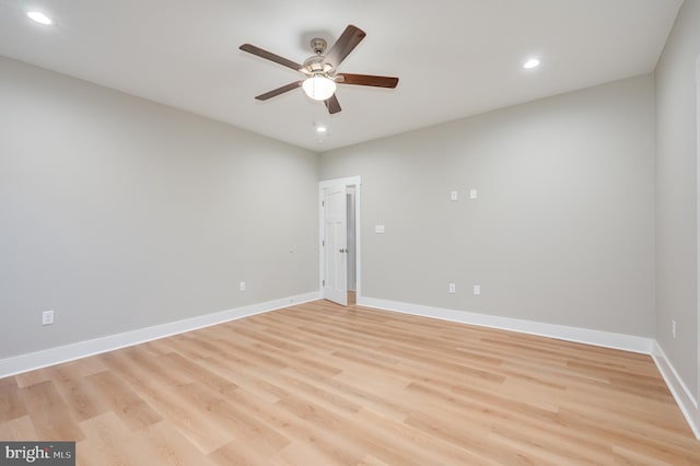 empty room with ceiling fan and light hardwood / wood-style floors