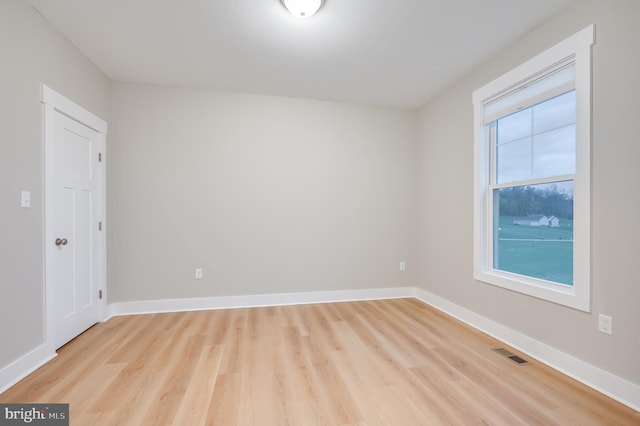 spare room with light hardwood / wood-style flooring