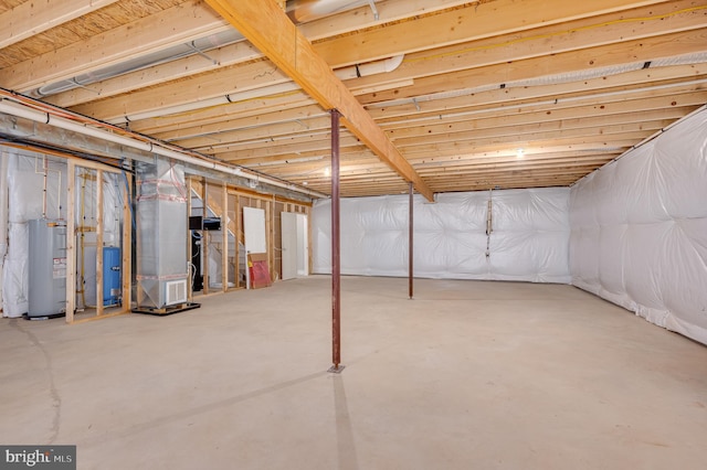 basement with electric water heater and heating unit