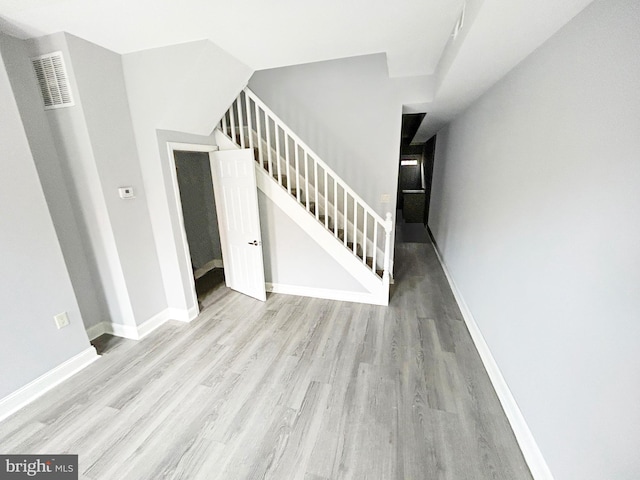 stairway with hardwood / wood-style flooring