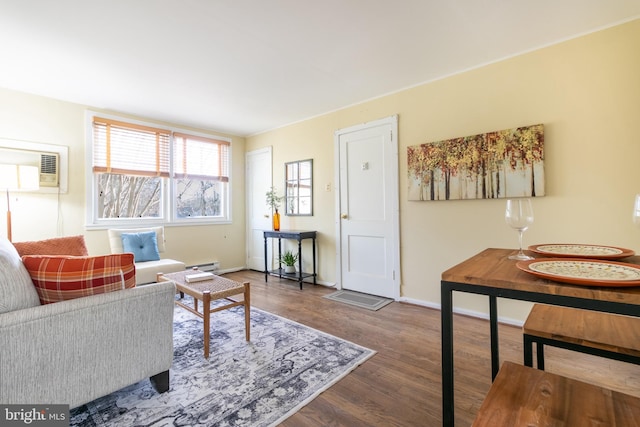 living room with dark wood-type flooring and a wall mounted AC