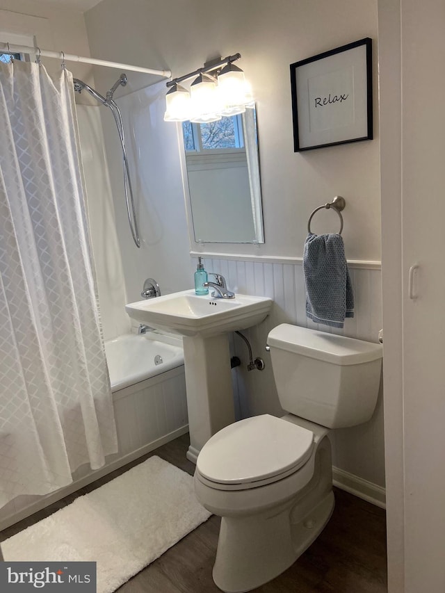 full bathroom featuring shower / bath combination with curtain, hardwood / wood-style flooring, toilet, and sink