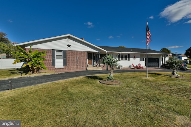 ranch-style home with a garage and a front lawn