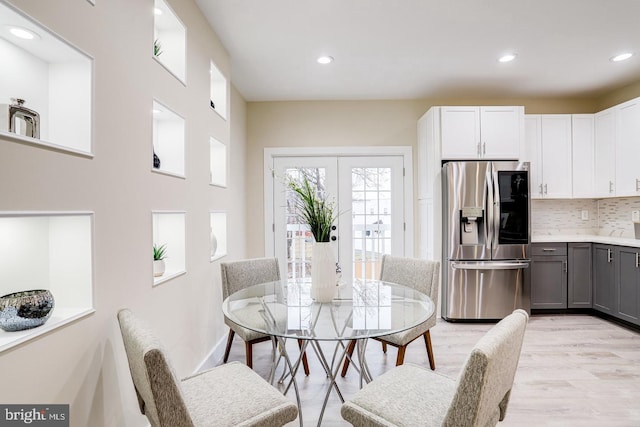 dining room with light wood-type flooring and french doors