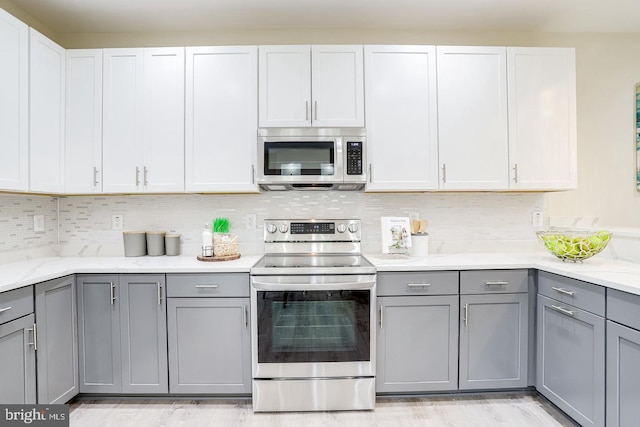 2405 Naylor Rd SE, Washington, DC 20020 - kitchen with stainless steel appliances, gray cabinetry, and decorative backsplash