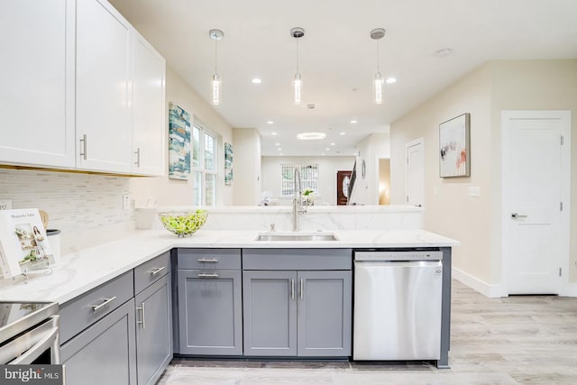 kitchen featuring gray cabinets, white cabinetry, appliances with stainless steel finishes, and sink