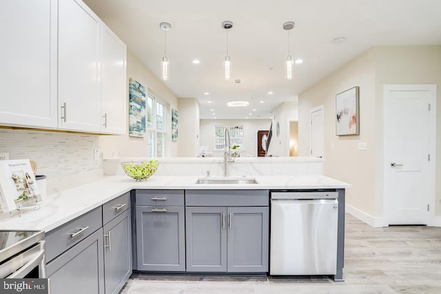 2405 Naylor Rd SE, Washington, DC 20020 - kitchen featuring stainless steel dishwasher, a sink, gray cabinets, a peninsula, and light wood finished floors