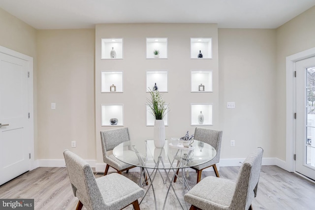 dining space with light hardwood / wood-style floors and plenty of natural light