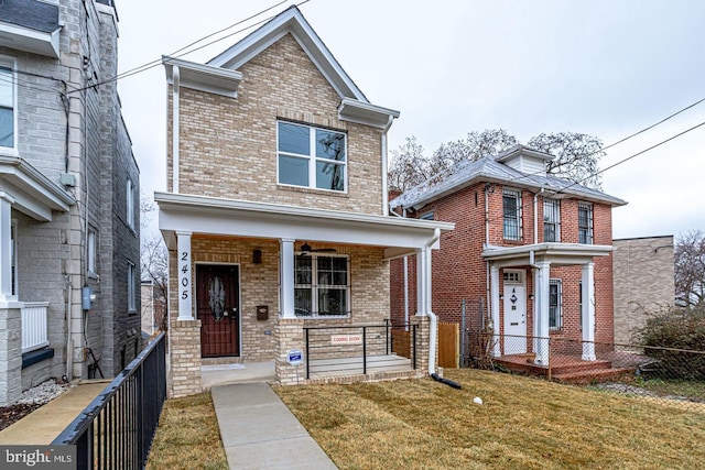 view of front of property featuring a front yard and covered porch