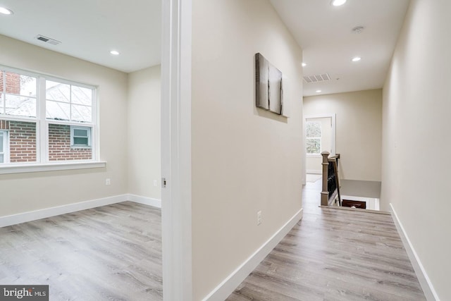 corridor with light hardwood / wood-style floors