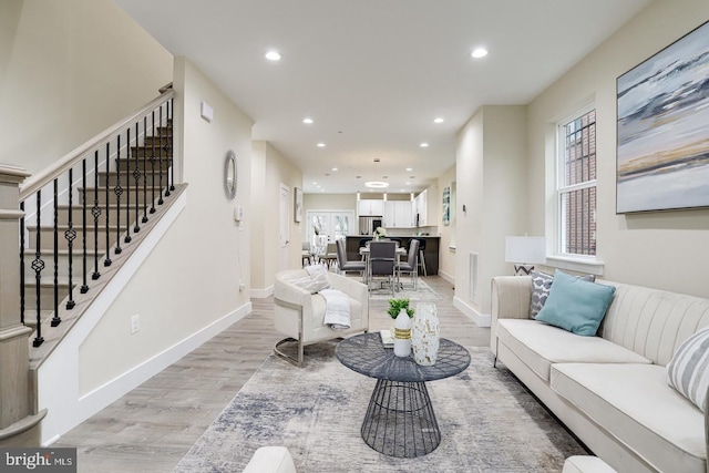2405 Naylor Rd SE, Washington, DC 20020 - living area featuring light wood-style flooring, recessed lighting, baseboards, and stairway