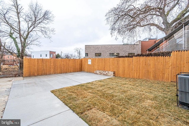 view of yard featuring central AC and a patio area