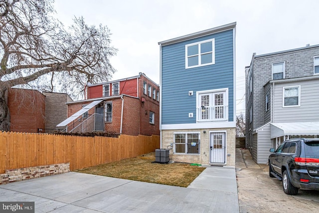 rear view of property featuring central AC unit