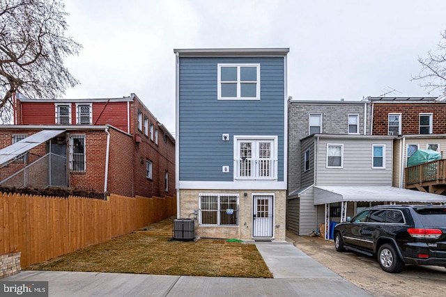 rear view of property featuring central AC unit