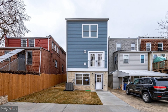 2405 Naylor Rd SE, Washington, DC 20020 - view of front of house featuring central air condition unit, fence, and brick siding