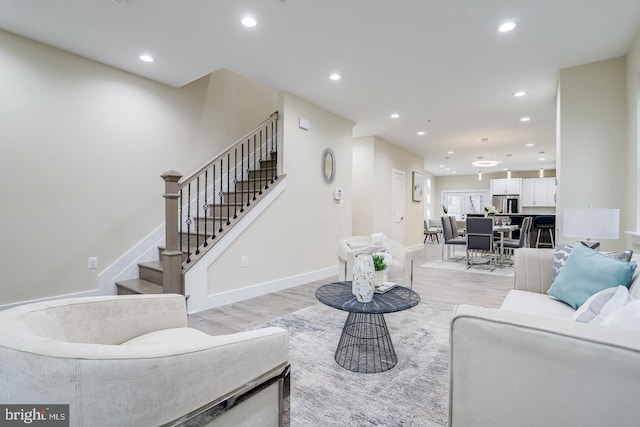 2405 Naylor Rd SE, Washington, DC 20020 - living area featuring light wood-style floors, recessed lighting, stairway, and baseboards