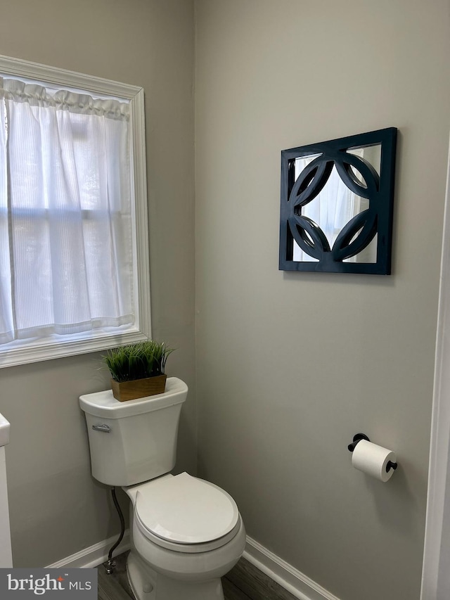 bathroom featuring hardwood / wood-style floors and toilet