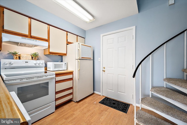 kitchen with white cabinets, white appliances, and light wood-type flooring