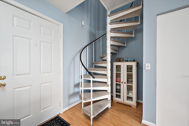 stairs featuring wood-type flooring and beverage cooler