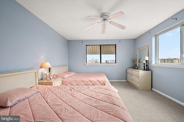 bedroom with ceiling fan and light carpet