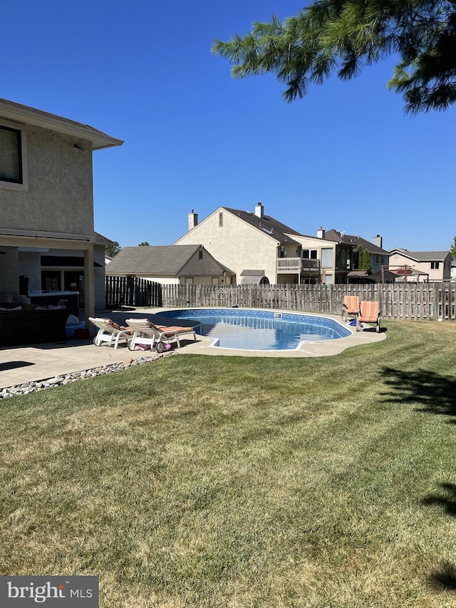 view of swimming pool with a lawn and a patio area