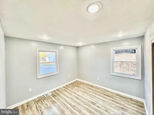 spare room featuring light hardwood / wood-style flooring