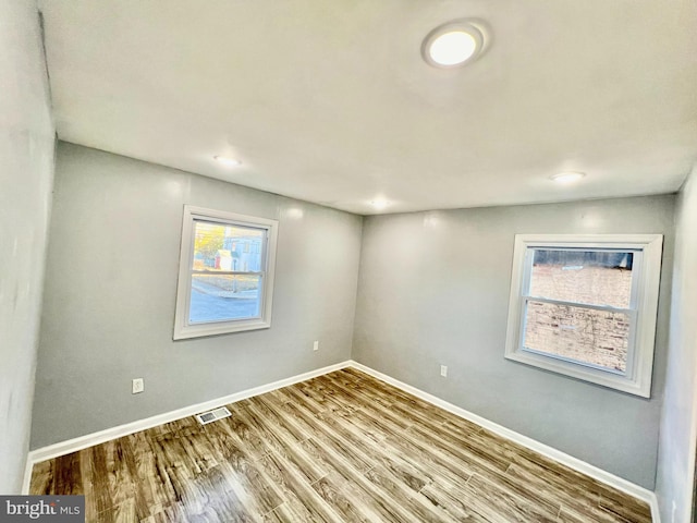 unfurnished room with hardwood / wood-style floors