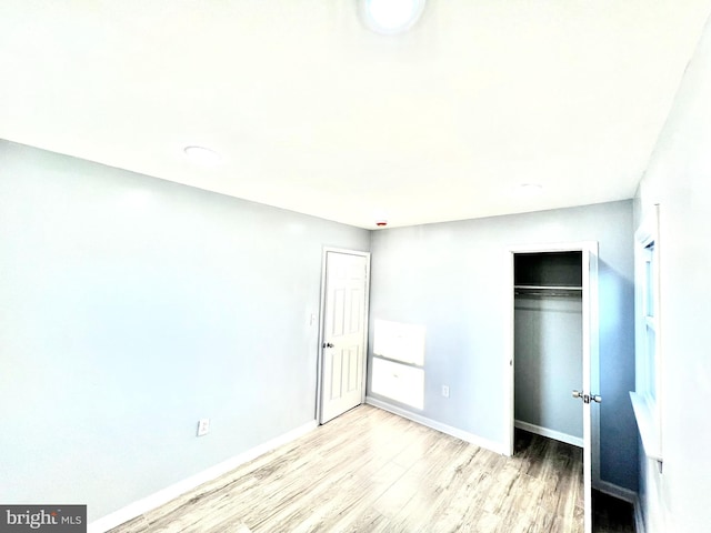 unfurnished bedroom with light wood-type flooring