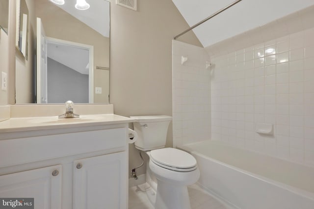 full bathroom with toilet, vanity, tiled shower / bath combo, and vaulted ceiling