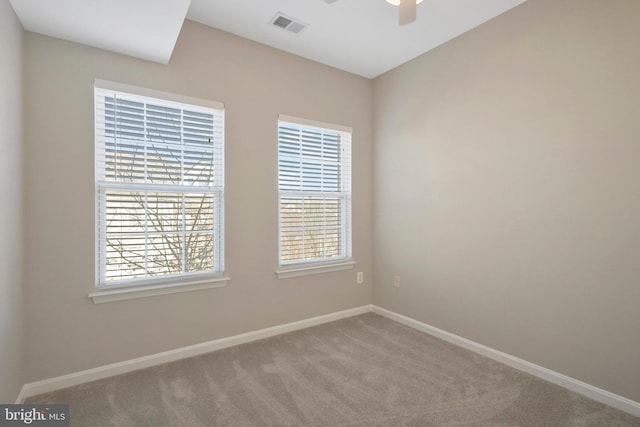 empty room with ceiling fan and carpet floors