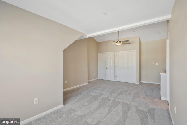 additional living space featuring light carpet, ceiling fan, and lofted ceiling