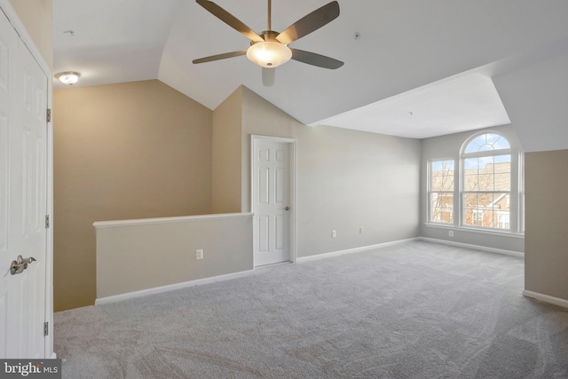 interior space with ceiling fan, light colored carpet, and lofted ceiling