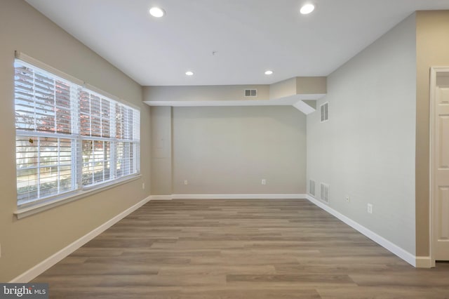 empty room with hardwood / wood-style floors